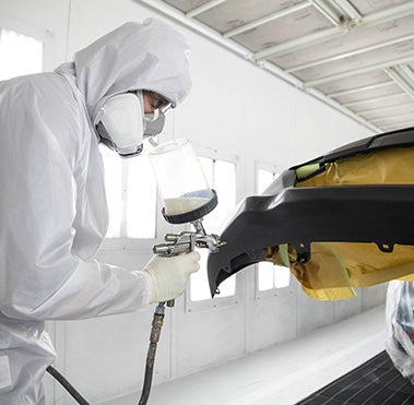 Collision Center Technician Painting a Vehicle | Randy Wise Toyota in Grand Blanc MI